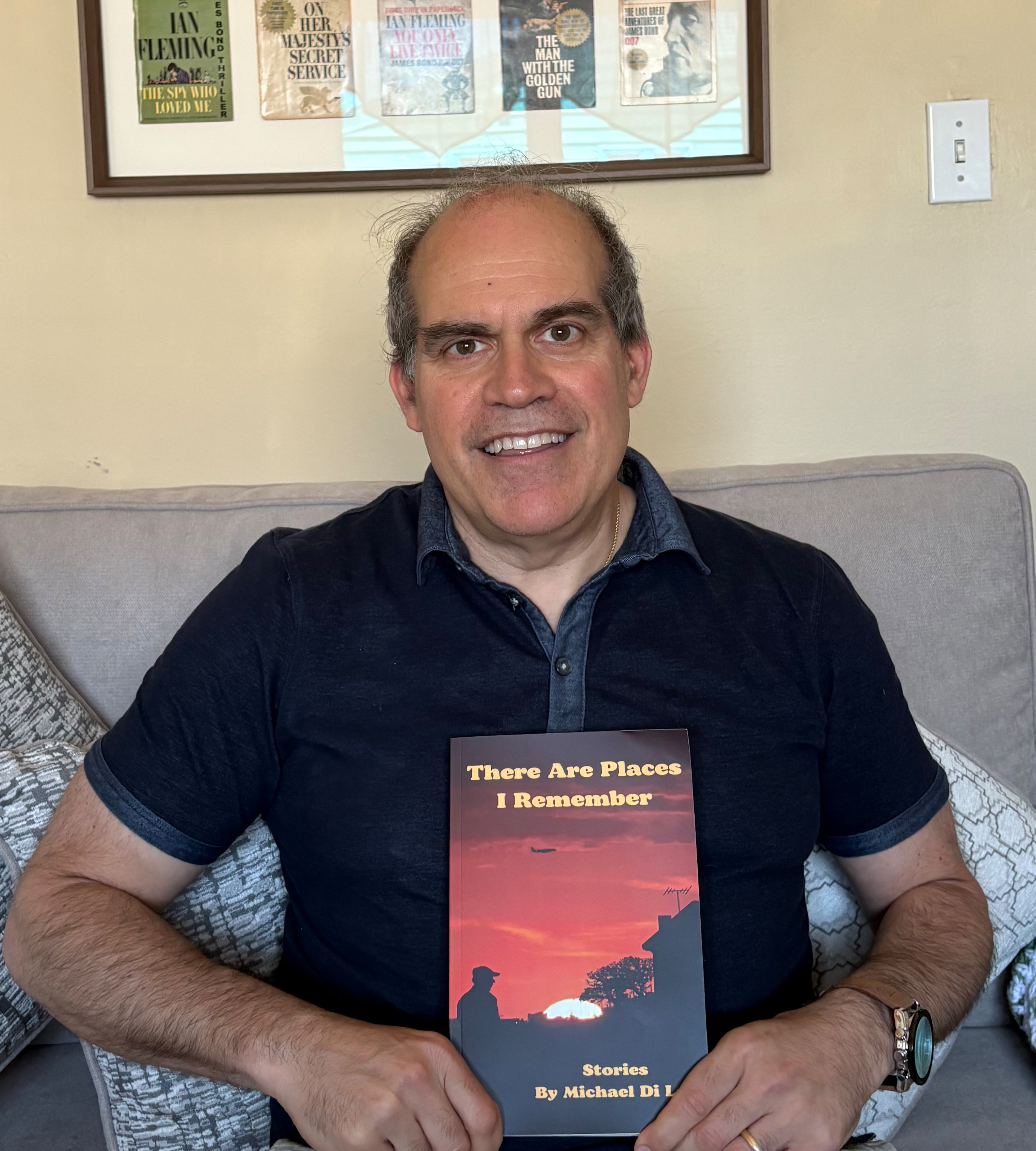 Mike DiLeo 89 holds copy of his Utica inspired book - There Are Places I Remember