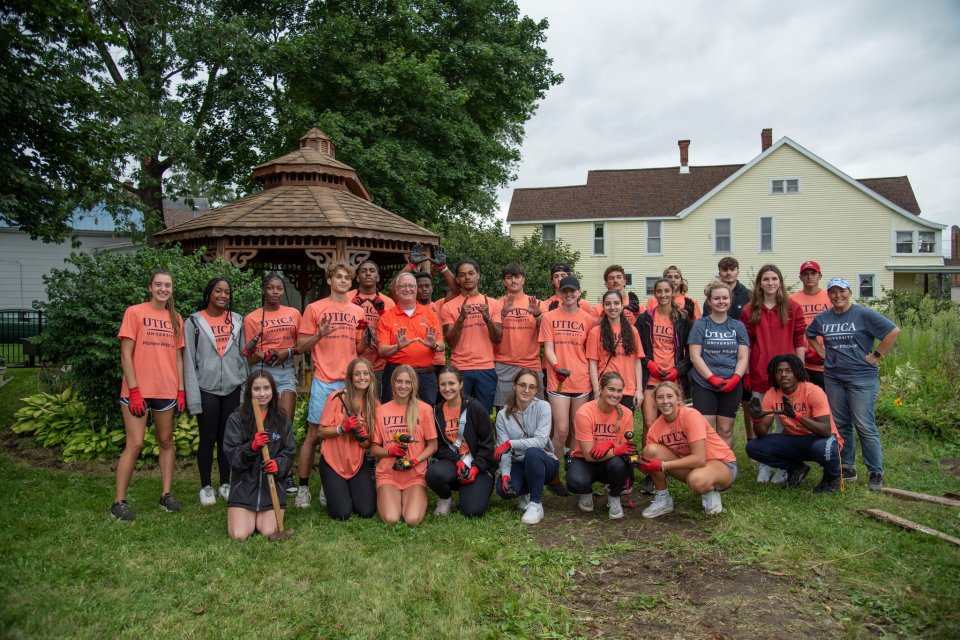 Group of students with President Pfannestiel at a Pioneer Pitch In Volunteer Site.